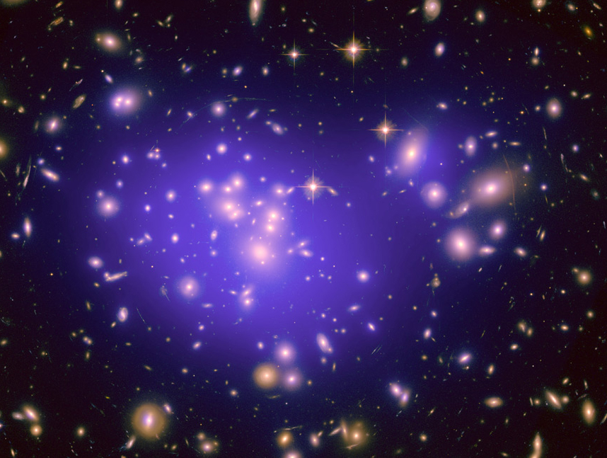 Dark matter cannot be photographed, but researchers can detect it and map it by measuring gravitational lensing. Its distribution is shown here in the blue overlay of the inner region of Abell 1689, a cluster of galaxies 2.2 billion light years away. (Credit: NASA/ESA/JPL-Caltech/Yale/CNRS)