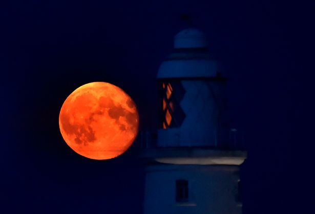 A Harvest Moon in 2014 at St Mary's Lighthouse, near Whitley Bay, North Tyneside. Both the Harvest Moon and the subsequent Hunter's Moon can take on an eerie orange hue. Picture: Owen Humphreys/PA Wire